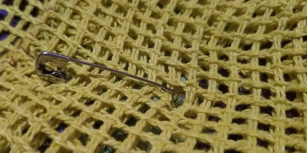 Pinning the backing to the rug.